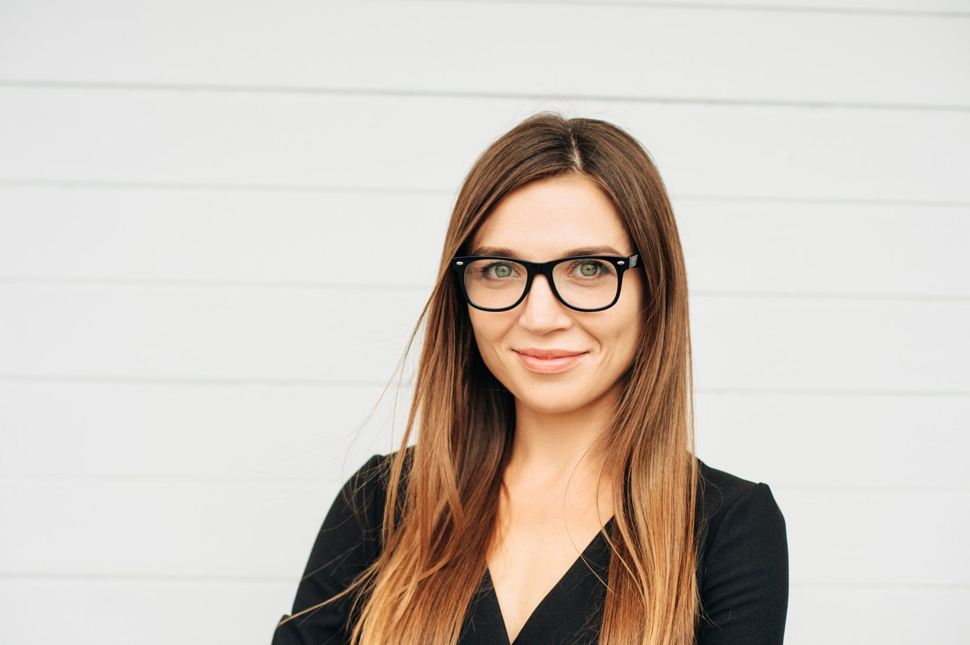 A smiling therapist with glasses