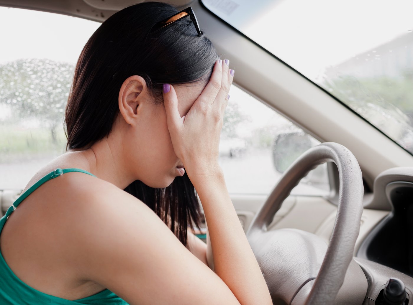 Young woman experiencing a panic attack while driving